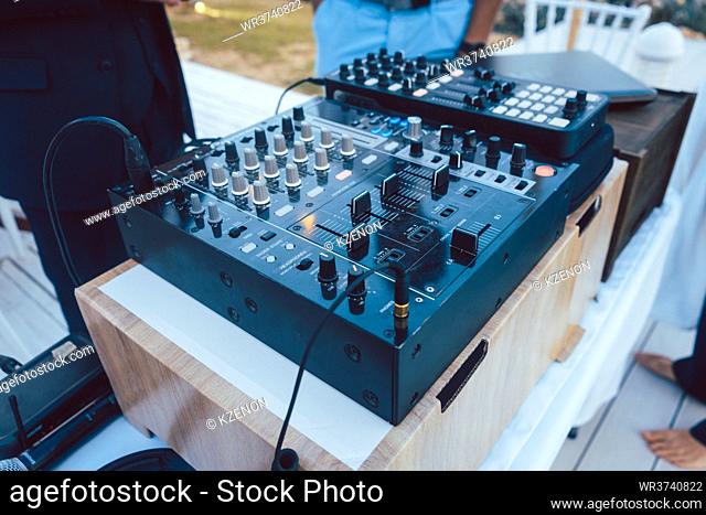 DJ mixing console at summer party waiting to play music