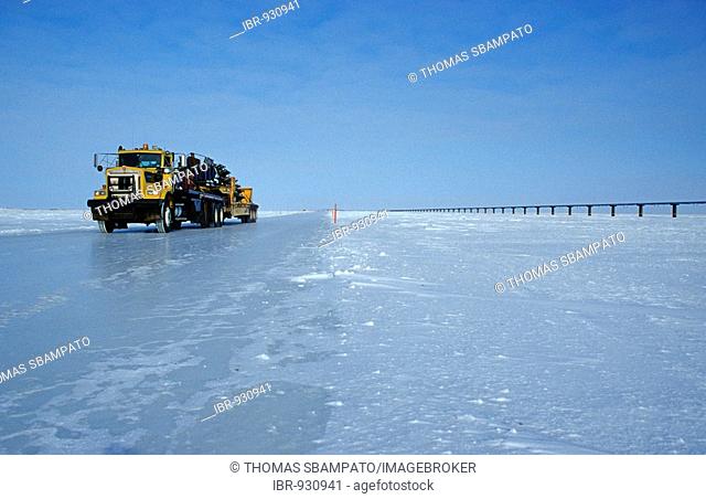Truck driving on an ice road, built by oil companies and used to connect individual oil drilling sites in winter, Prudhoe Bay, Alaska, USA