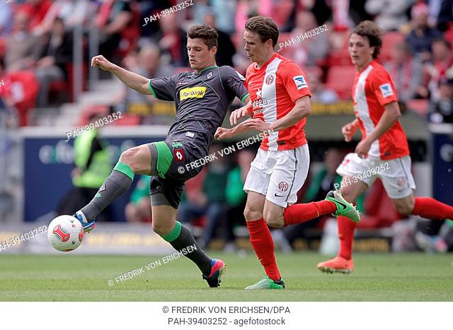 Mainz's Nicolai Mueller (C) vies for the ball with Gladbach's Granit Xhaka (L) during the German Bundseliga match between FSV Mainz 05 and Borussia...