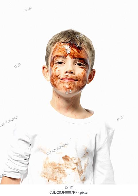 Boy covered in chocolate sauce