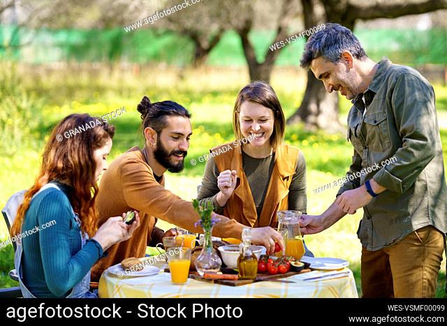 Friends enjoying a healthy vegan breakfast in the countryside