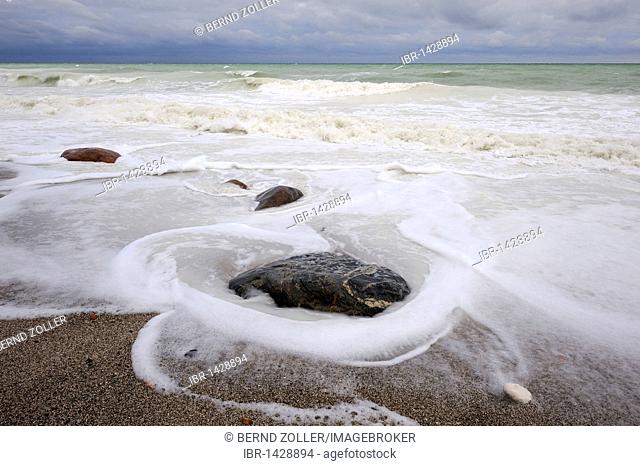 Rising waves wash around a stone, stormy weather, Baltic Sea, Moen Island, Denmark, Scandinavia, Europe