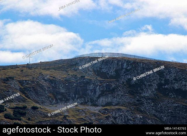view from bärenkopf (1991m) to the stanser joch (2102m) summit cross, cloud mood, avalanche fence, achensee, tyrol, austria