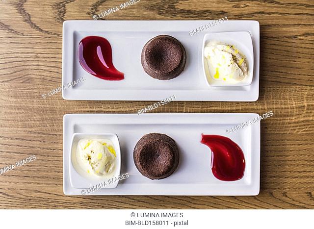 Platters of chocolate souffle dessert with ice cream and sauce