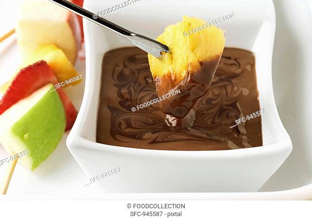 Chocolate fondue with skewered fruit