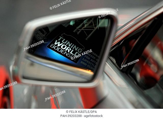 The sign for Tuning World Bodensee is reflected in a side mirror of Mercedes Carlsson CLS during a press tour of Tuning World Bodensee in Friedrichshafen