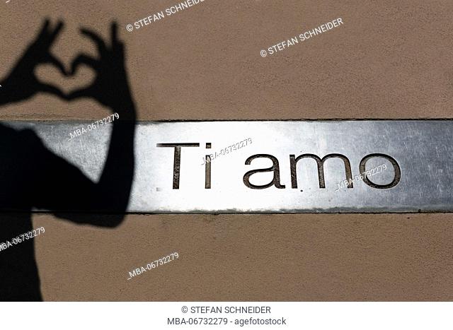 Ti amo inscription with with shadow of hands building a heart in the gardens of Trauttmansdorff Castle close Merano in South Tirol
