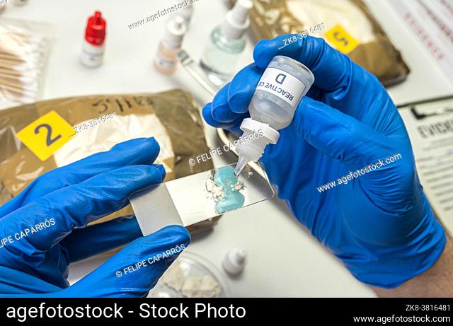 Scientific police hold positive drug reagent at crime lab, conceptual image