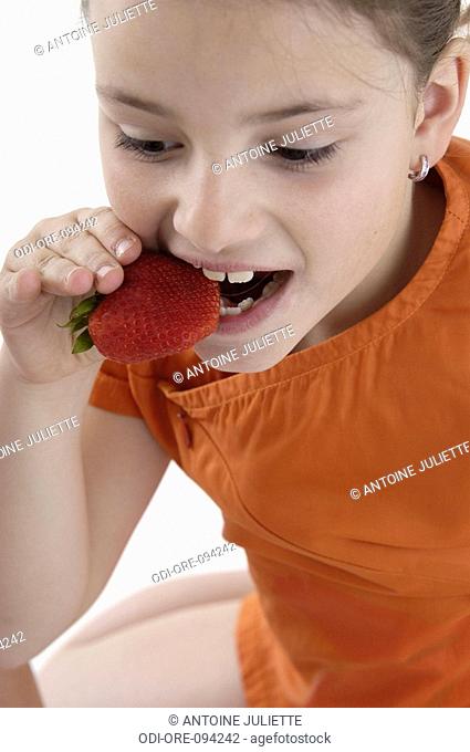 Little girl with strawberry