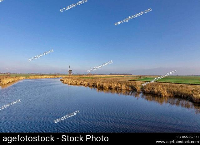 Windmill the Achterlandse molen near the Dutch village Groot-Ammers in the region Alblasserwaard - Image