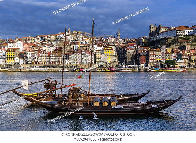 Offley Port wine boats called Rabelo Boats on a Douro River in Vila Nova de Gaia city. Porto city river bank on background