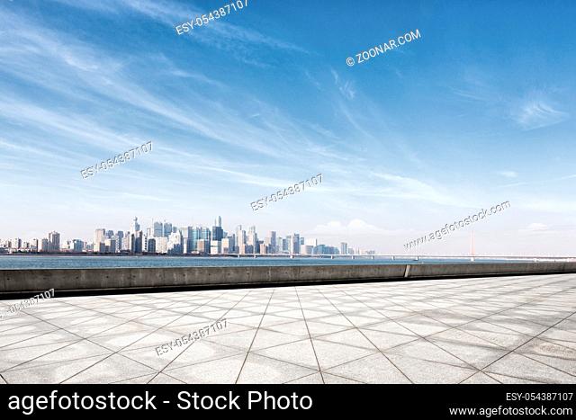 cityscape of hangzhou in blue cloud sky from emtpy marble floor