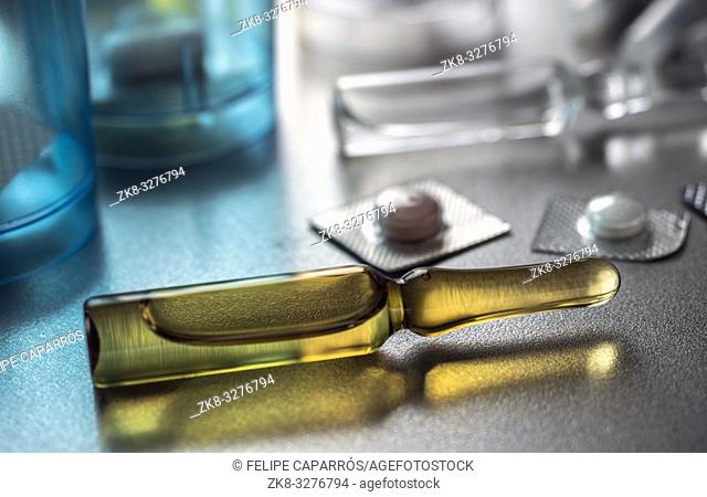 Diverse medication in glasses monodose along with Blister glass in hospital, conceptual image, horizontal composition