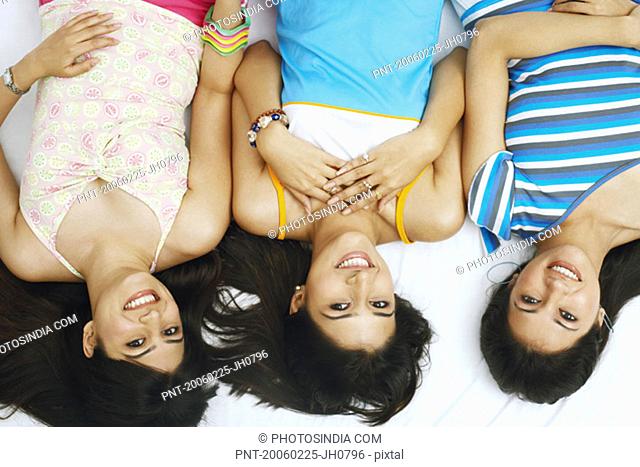High angle view of three young women smiling
