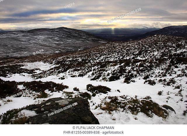 View of snow covered upland habitat with distant sunbeams, Monadhliath Mountains, Strathspey, Cairngorm N P , Highlands, Scotland, december