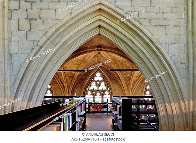 Selexyz Dominicanen Bookshop, built within a former 13th century Gothic church building. Shelving and displays and views of the arched roof