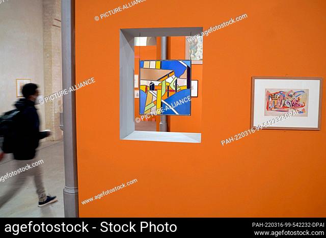 16 March 2022, Berlin: A repeat segment of a stained glass window (l) and a collage by the artist André Thomkins are on display in the special exhibition...