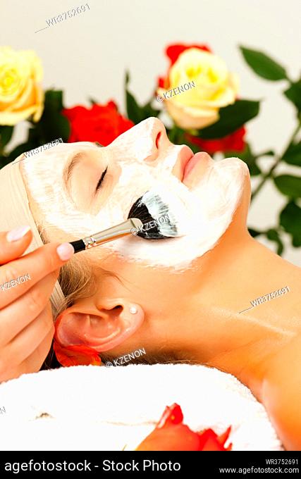 Woman having a mask or cream applied in the course of a beauty or wellness treatment