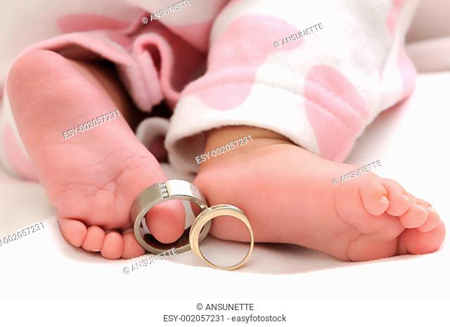 wedding rings on the toes of a baby girl