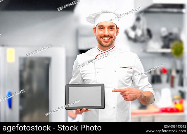 male chef showing tablet pc at restaurant kitchen