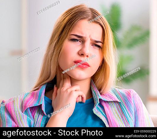 The young woman suffering from sore throat pain