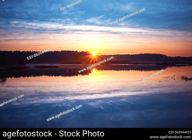 Beautiful Sunrise over Calm Lake, River in autumn morning. Sunset
