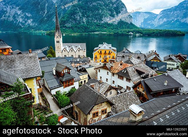 Hallstatt buildings roofs and Lutheran Church with lake and mountins in background, Salzkammergut region, Austria, Alps. Europe