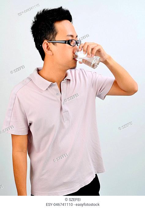 Asian male drinking water