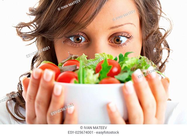 Young woman preparing healhty salad isolated on white background