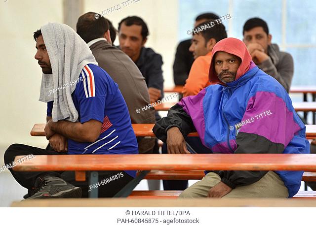 Asylum seekers from Pakistan sit in a tent set up by the refugee reception facility in Ingelheim, at Frankfurt-Hahn Airport in Lautzenhausen,  Germany