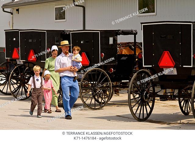 Amish and Mennonites with their horse and buggies at a hitchpost in Shipshewana, Indiana, USA