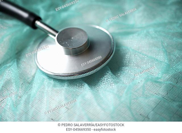 Close up of an stethoscope on a green surface