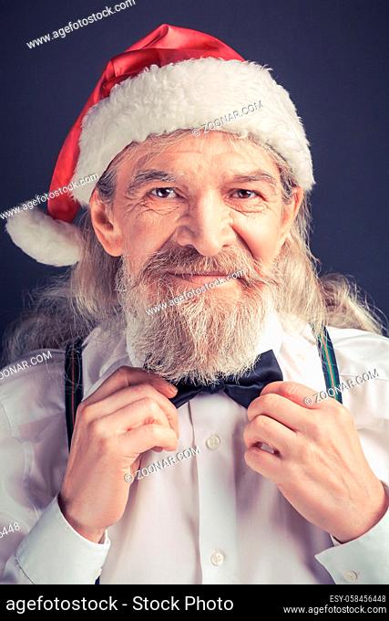 New year, Santa Claus adjusting bow tie. Happy Santa getting ready fo Christmas party