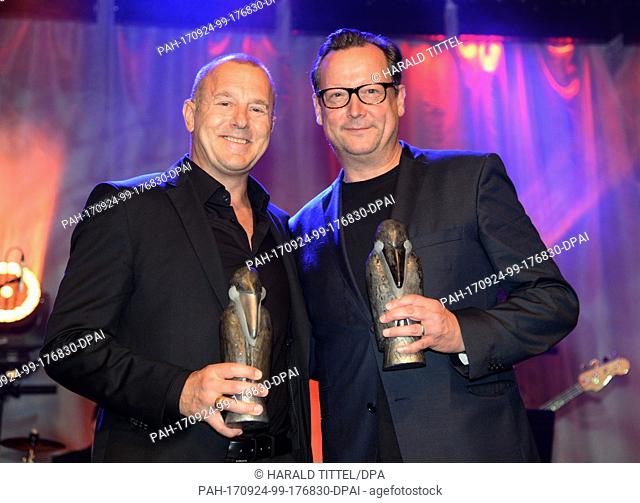 Actors Heino Ferch (L) and Matthias Brandt hold their film awards ""Roland""Â which they recieved at the Thriller Festival ""Tatort Eifel"" in Daun, Germany