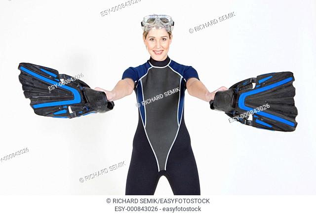 portrait of woman wearing neoprene with flippers and diving goggles