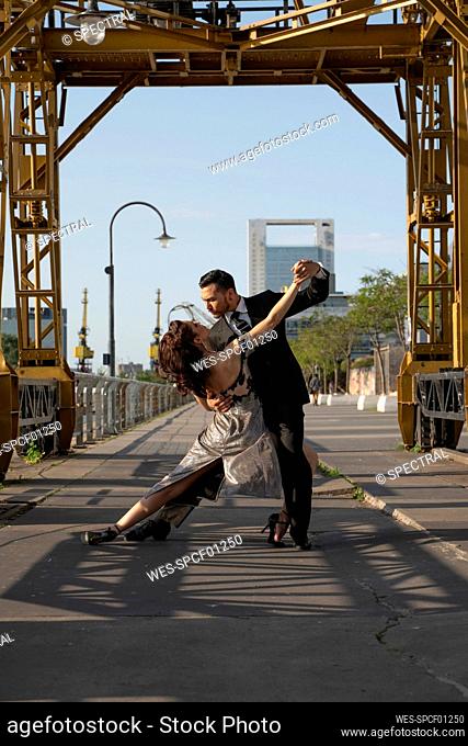 Male and female dancers practicing Tango dance on road