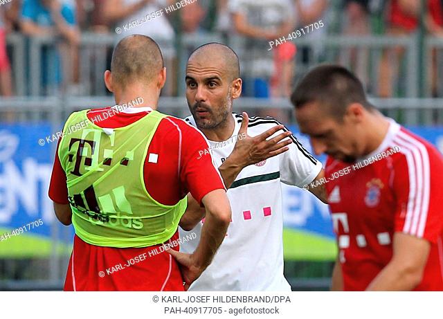 Munich's head coach Pep Guardiola talks to player Arjen Robben during a training session in Arco, Italy, 08 July 2013. German Bundesliga soccer club Bayern...