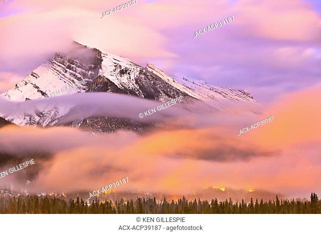 Mount Rundle, Banff townsite at dusk and dramatic clouds. Banff National Park, Alberta, Canada