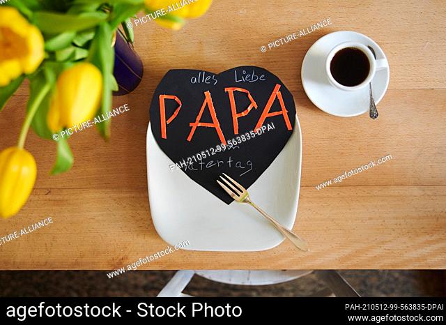 ILLUSTRATION - 11 May 2021, Berlin: ""Dad - Happy Father's Day"" is written on a homemade card that sits on the breakfast plate