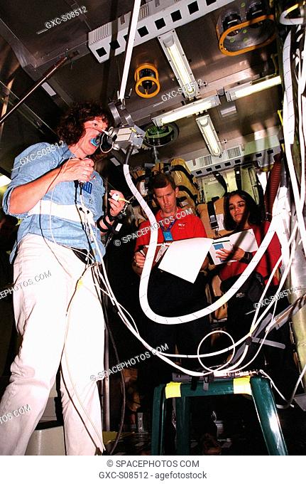 06/11/2001 -- At SPACEHAB, Cape Canaveral, Fla., Mission Specialist Laurel Blair Salton Clark practices an experiment while Commander Rick Douglas Husband and...