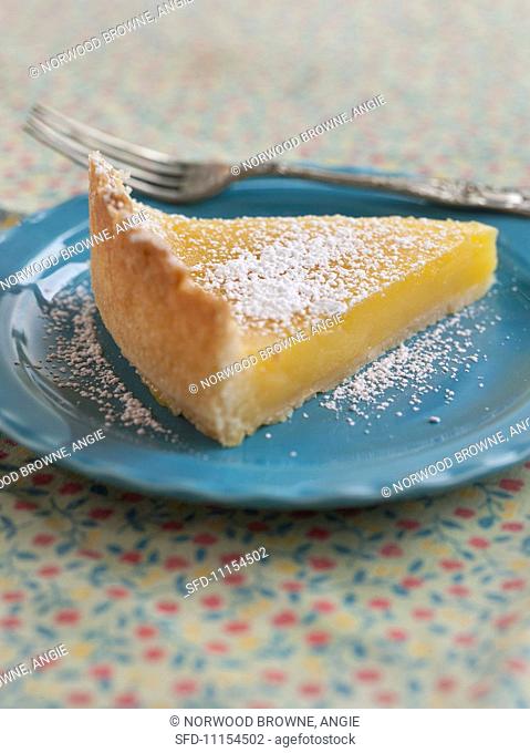 A Slice of Lemon Tart with Powdered Sugar