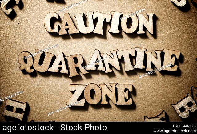 Caution Quarantine Zone sentence on a brown paper