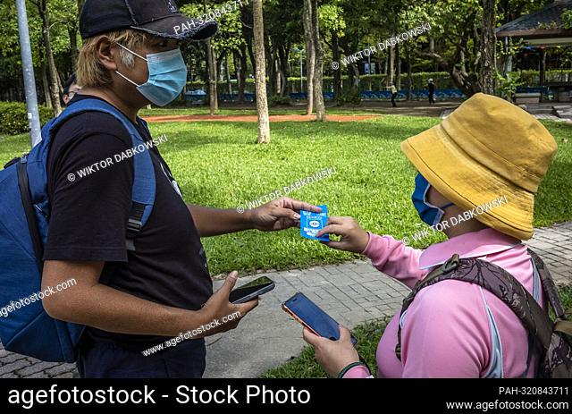 Gamers exchange gaming cards as Pokemon hunters gathered at Da’an Forest Park in Taipei, Taiwan during Pokémon GO Safari Zone on 21/10/2022 by Wiktor Dabkowski