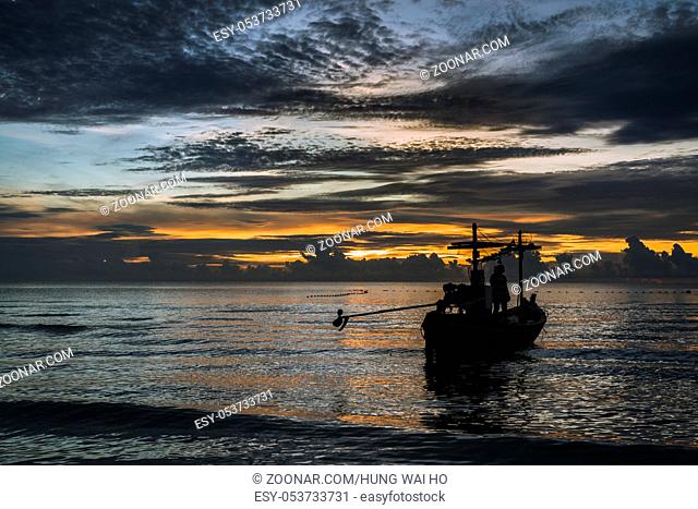 A beautiful tropical dawn with a fishing boat