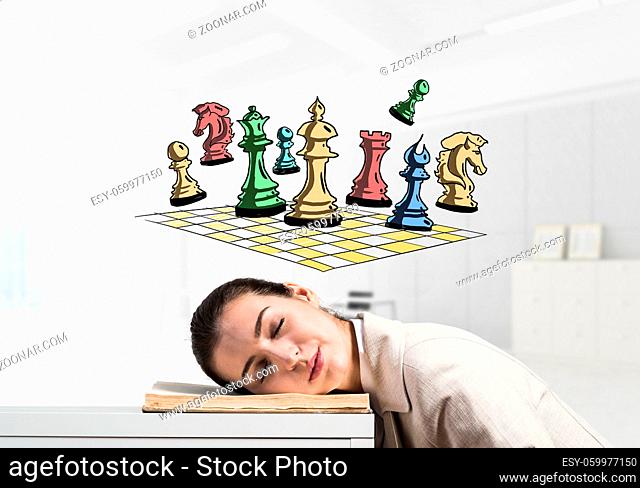 Happy business woman sleeping on desk. Chess figures on chessboard cartoon drawing above head. Smiling female worker in white suit dreaming