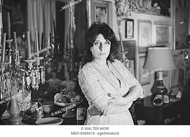The actress and icon of Italian cinema Anna Magnani posing leaned against a cupboard for a photo shooting made in her house. Rome, May 1968