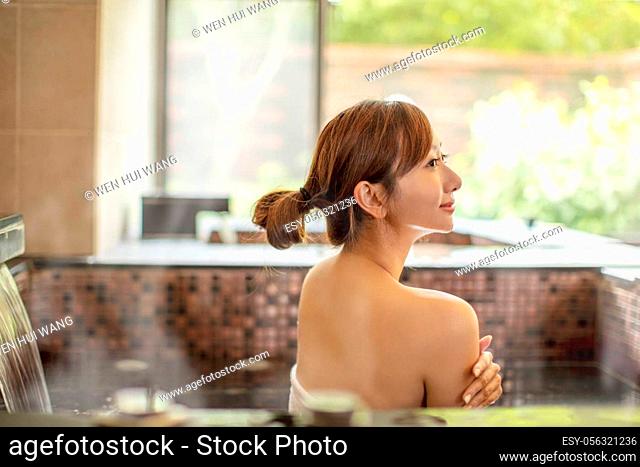 beautiful Young woman relaxing in hot spring