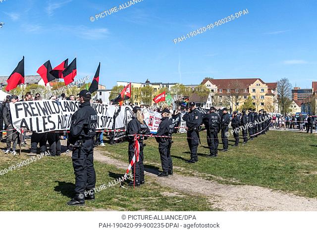 20 April 2019, Schleswig-Holstein, Flensburg: Demonstrators protest loudly against a fan festival and a short concert of the controversial South Tyrolean German...