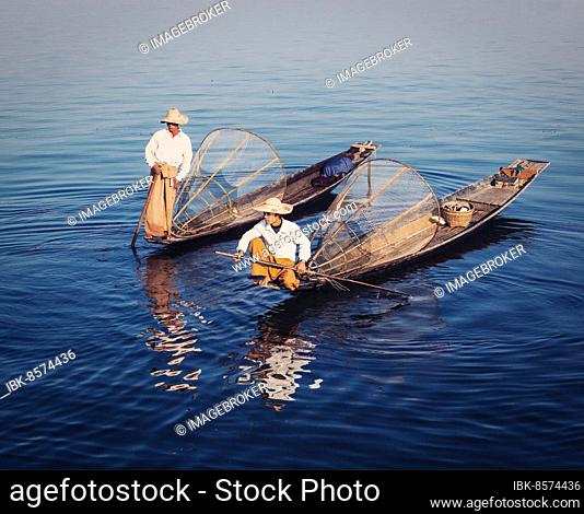 Myanmar travel attraction, Traditional Burmese fishermen with fishing net at Inle lake in Myanmar famous for their distinctive one legged rowing style