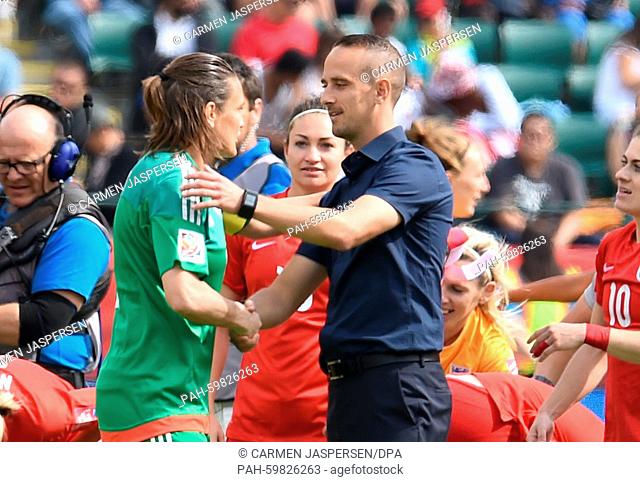 Germany's goalkeeper Nadine Angerer (L) congratulate England's head coach Mark Sampson after the FIFA Women's World Cup 2015 third place soccer match between...